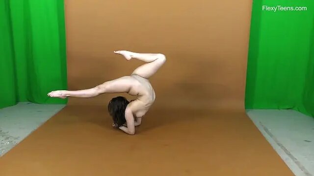 Petite ballerina Rima stretches legs in acrobatic yoga
