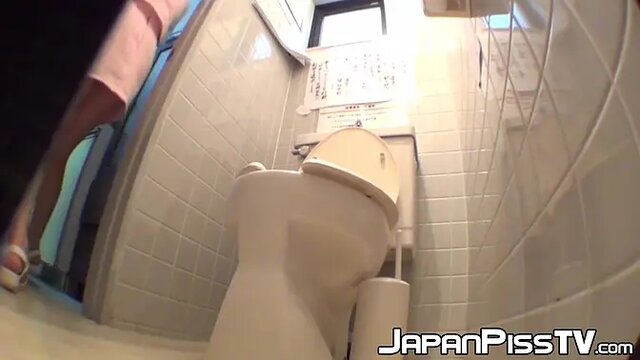 Hidden camera captures Japanese babes peeing in public toilet