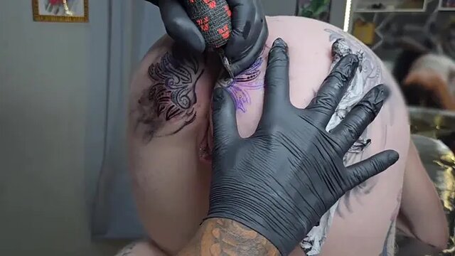 Stunning blonde with big round ass and anal tattoo gets her tight pussy pierced